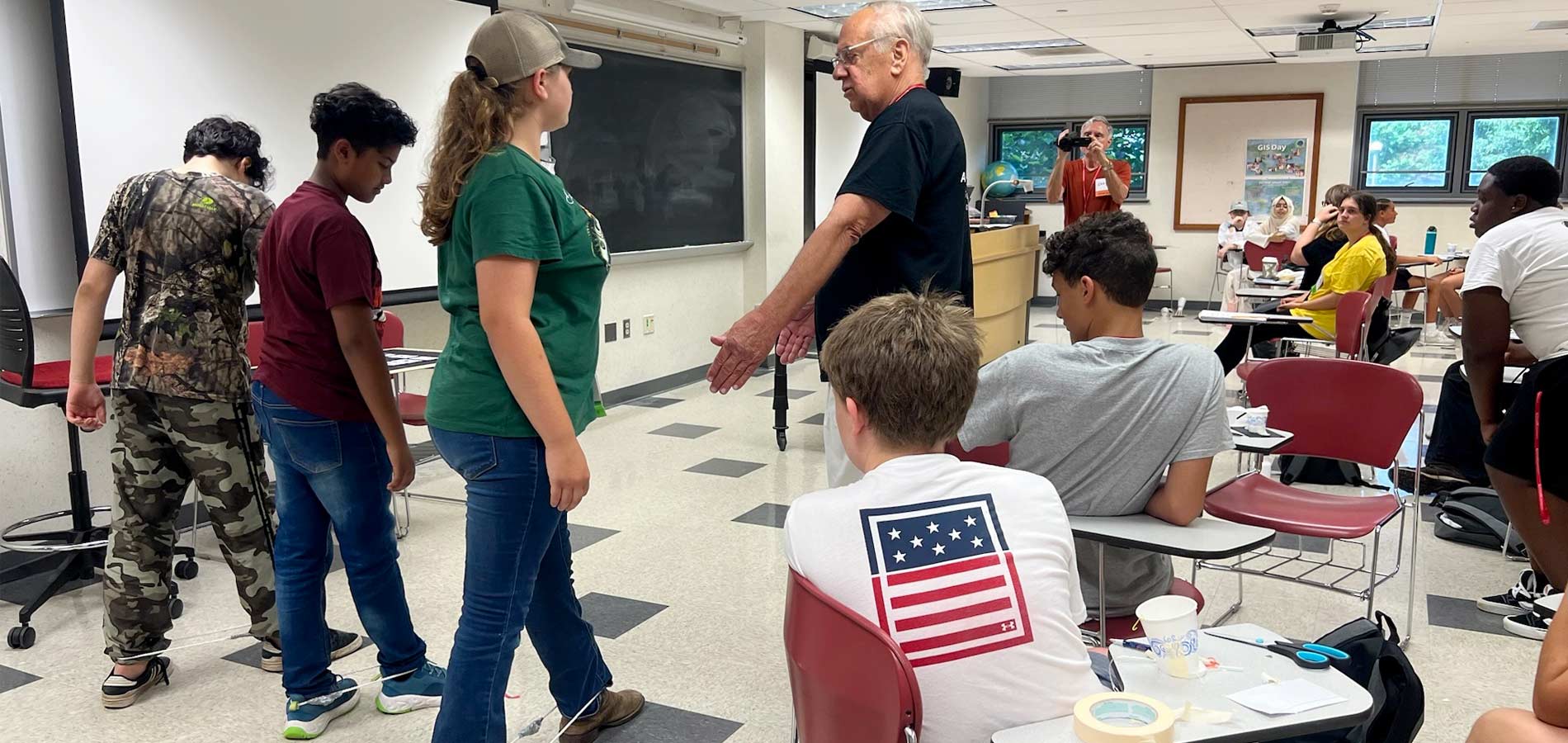 Rolf Schlake, STEM YEA Chair, has a teaching moment where he explained frequency and wavelength to students.