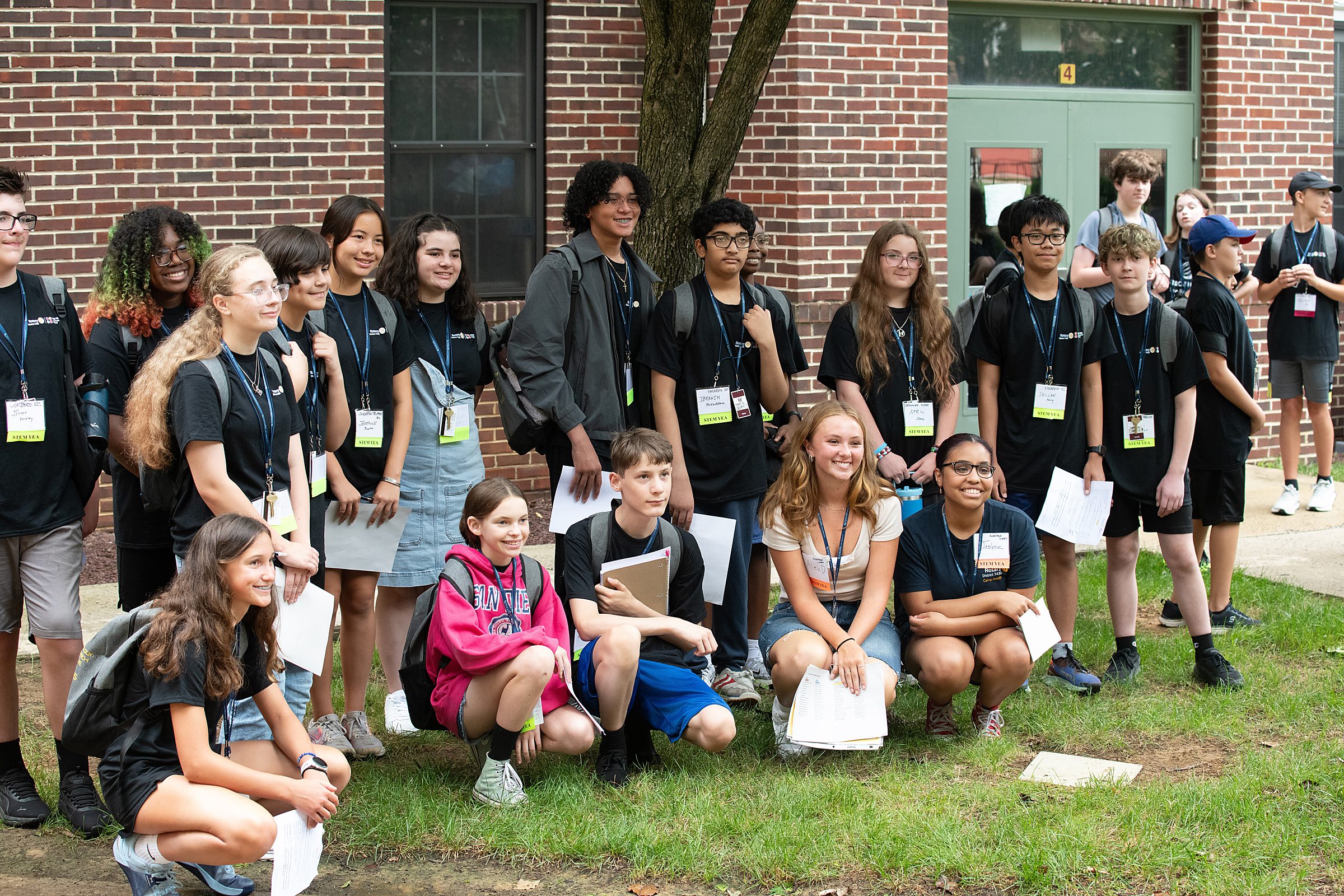 Freshly registered students settle in for a picture with volunteers Jasleen and Alex.