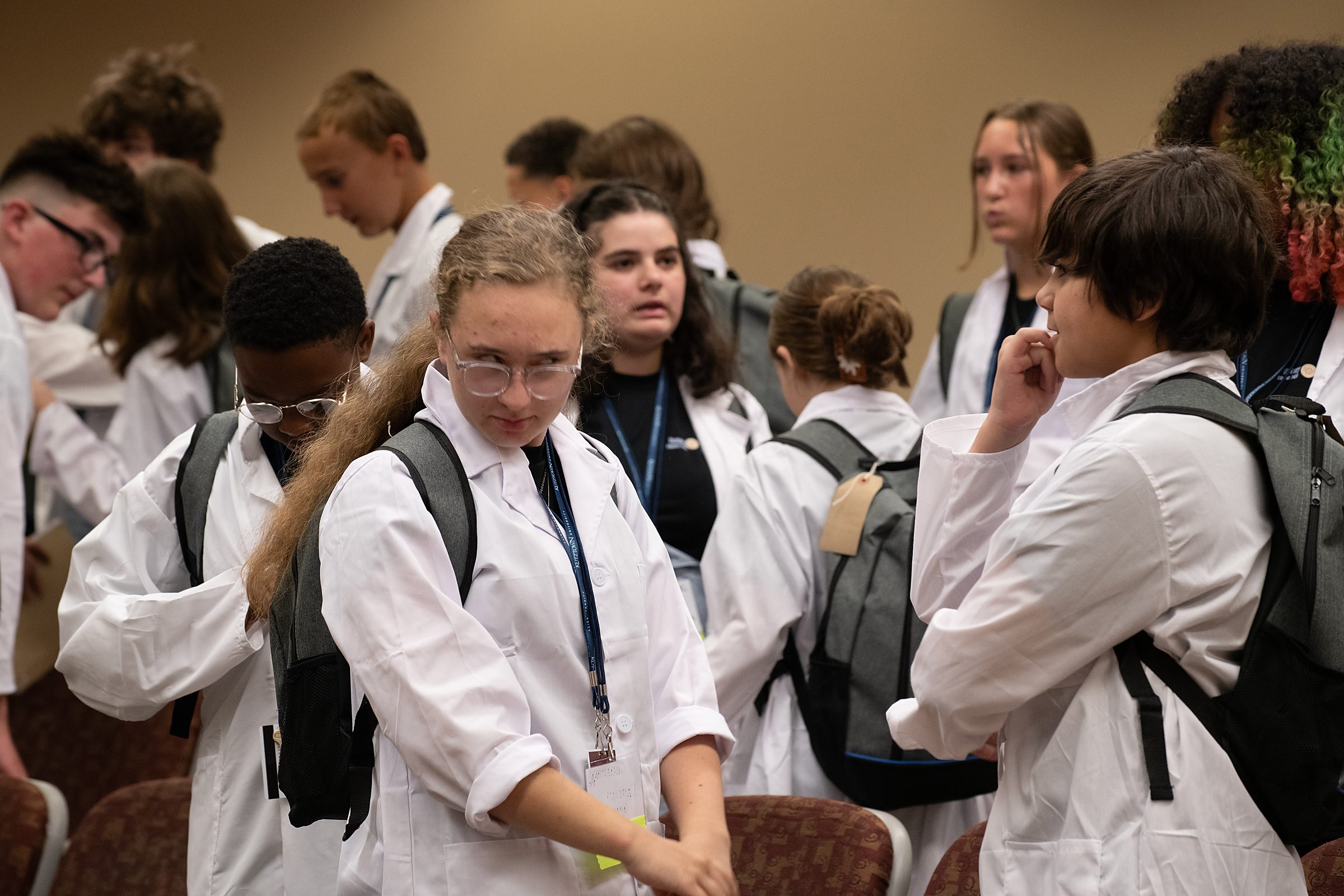Students don their white lab coats during the Academy's traditional ceremony.