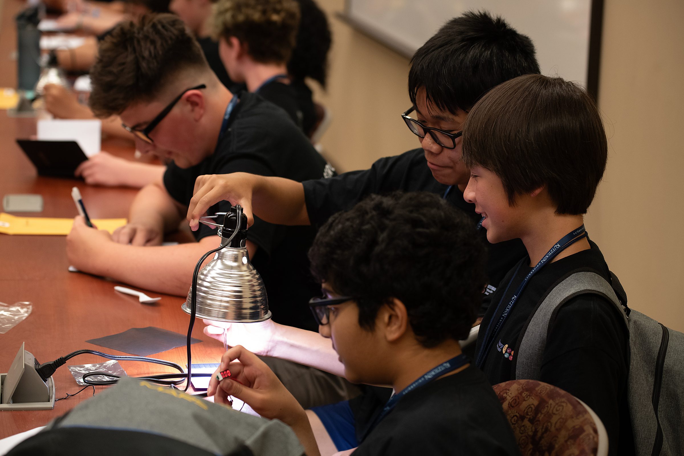 Students test mini solar panels, observing how voltage output changes with the angle of the light