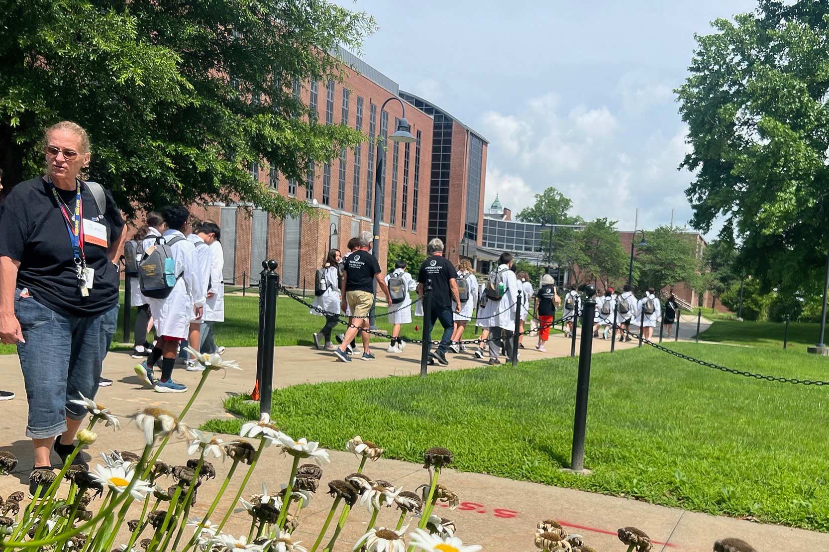 STEM YEA volunteers escorting students